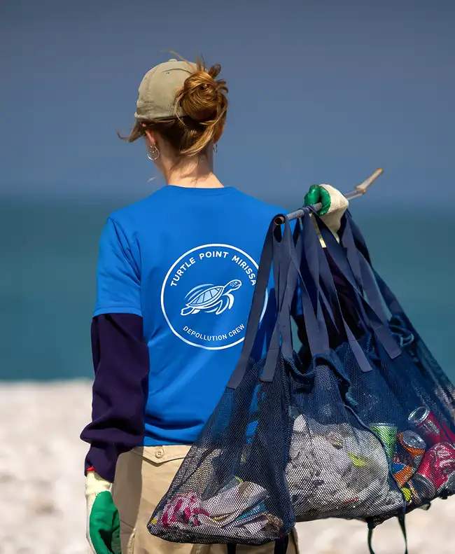 Eco-friendly beach cleanup team member protecting marine life